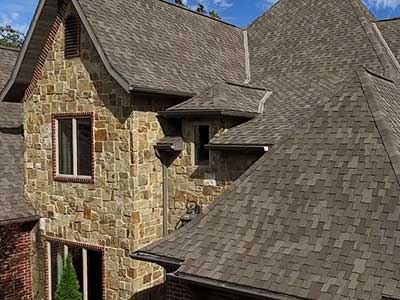 Front view of a typical mid-class home with brown Tamko shingles on its roof